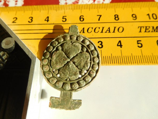 Neznámý artefakt s lipovou ratolestí v kruhu.